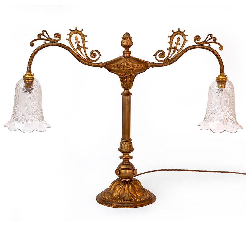 Antique Edwardian decorative cast brass table lamp fitted with two arms holding fluted cut glass shades. (c.1900)